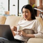 remote-employee-sits-with-coffee-laptop_482257-128097